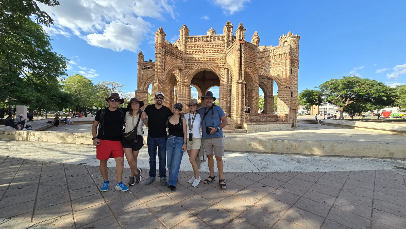All six, together in the plaza