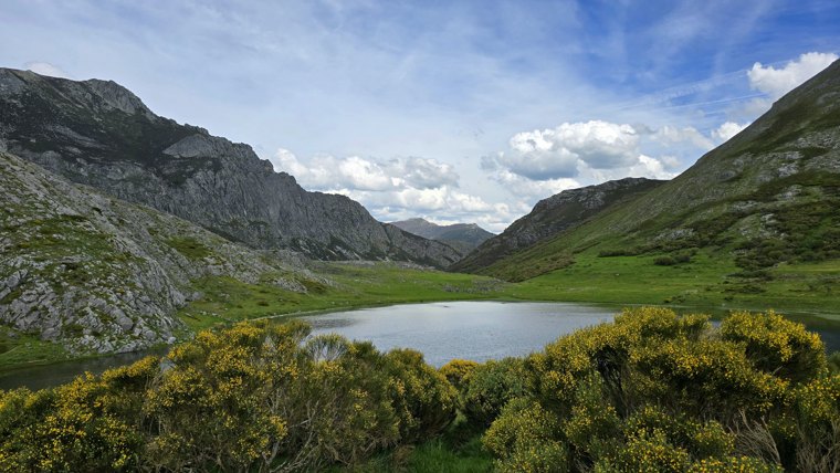 Still water beneath the mountain ridges.